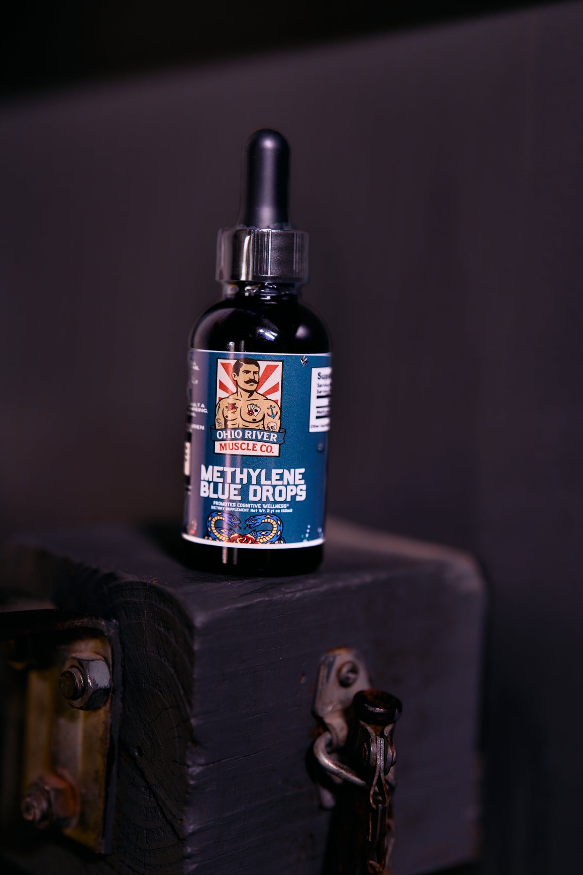 Ohio River Muscle Co. Methylene Blue Drops dropper bottle on a wood block