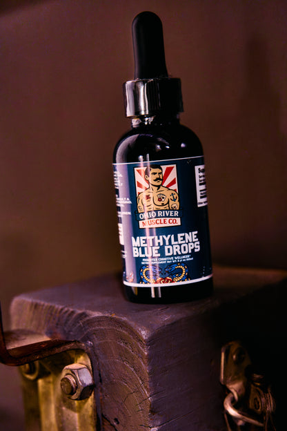 Methylene Blue Drops dropper bottle on a wood block